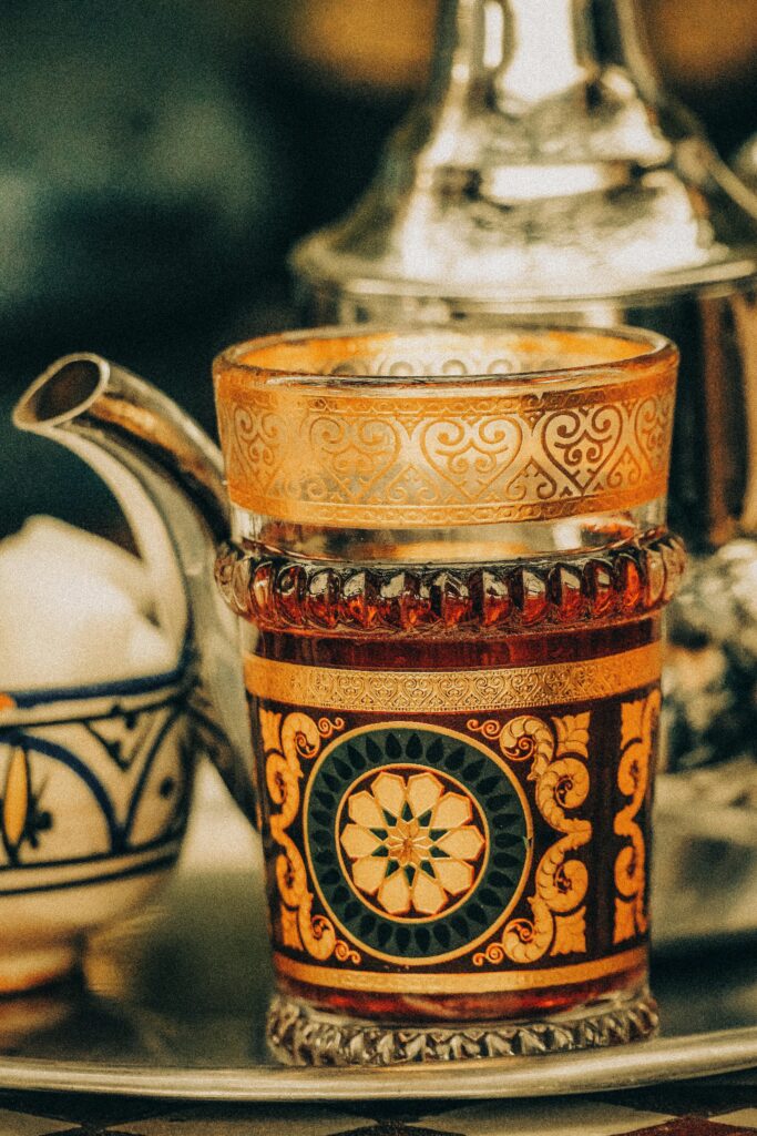 Intricate Moroccan tea set with ornate glass and teapot design, Marrakesh.
